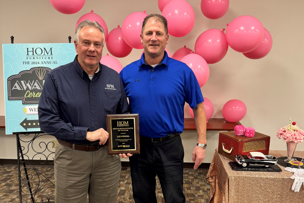 Dan Lentz (left), Safety Manager/HR Representative at HOM Furniture, presents Lee Wendel, Director of Loss Prevention at SFM, with the retailer’s Service Representative of the Year award.